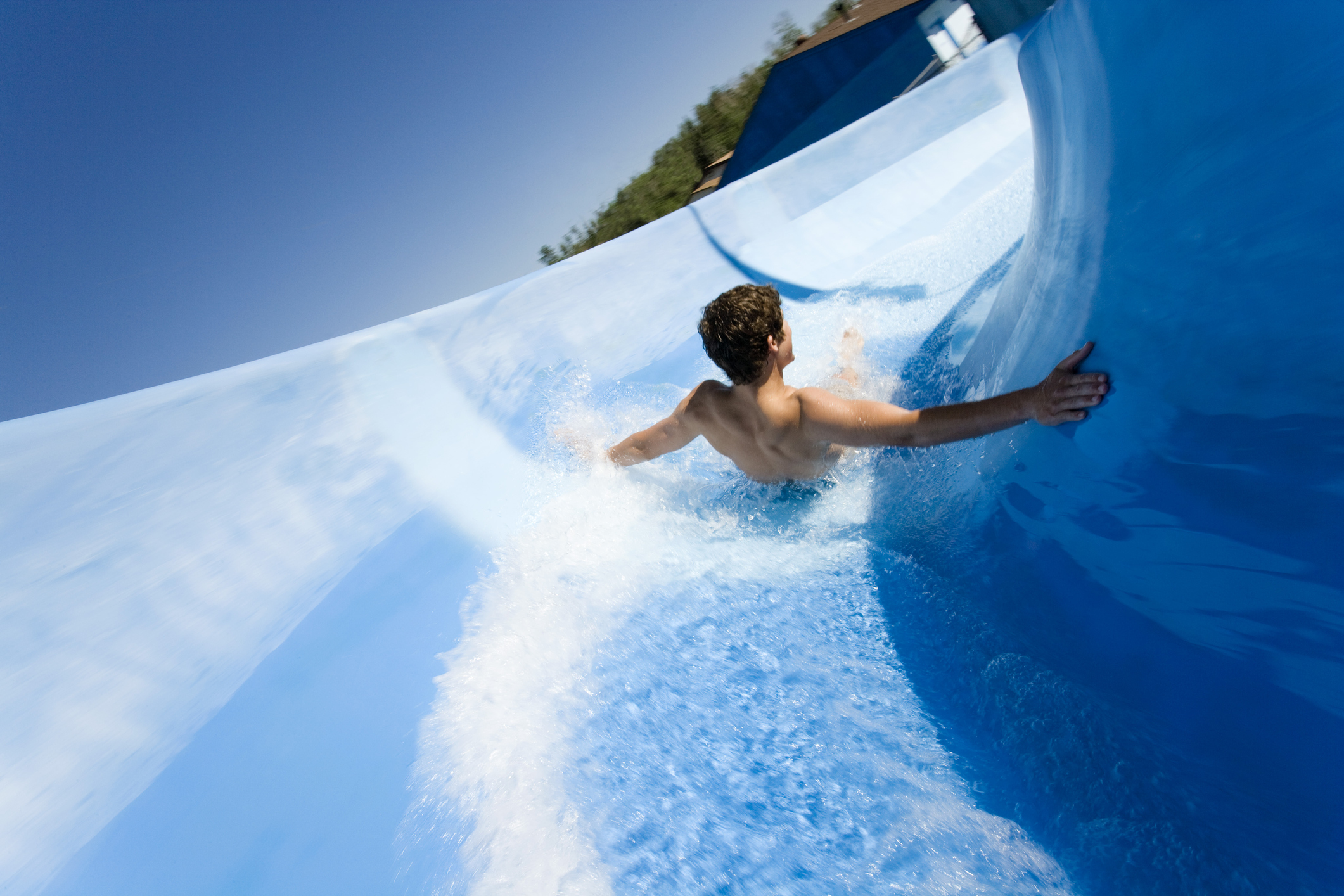 Man going down water slide at waterpark