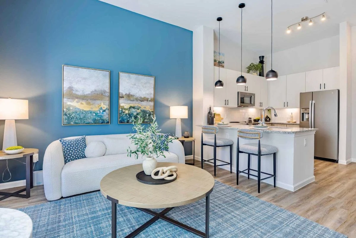 Interior living room and kitchen view of The Abbey at Veramendi apartments. 