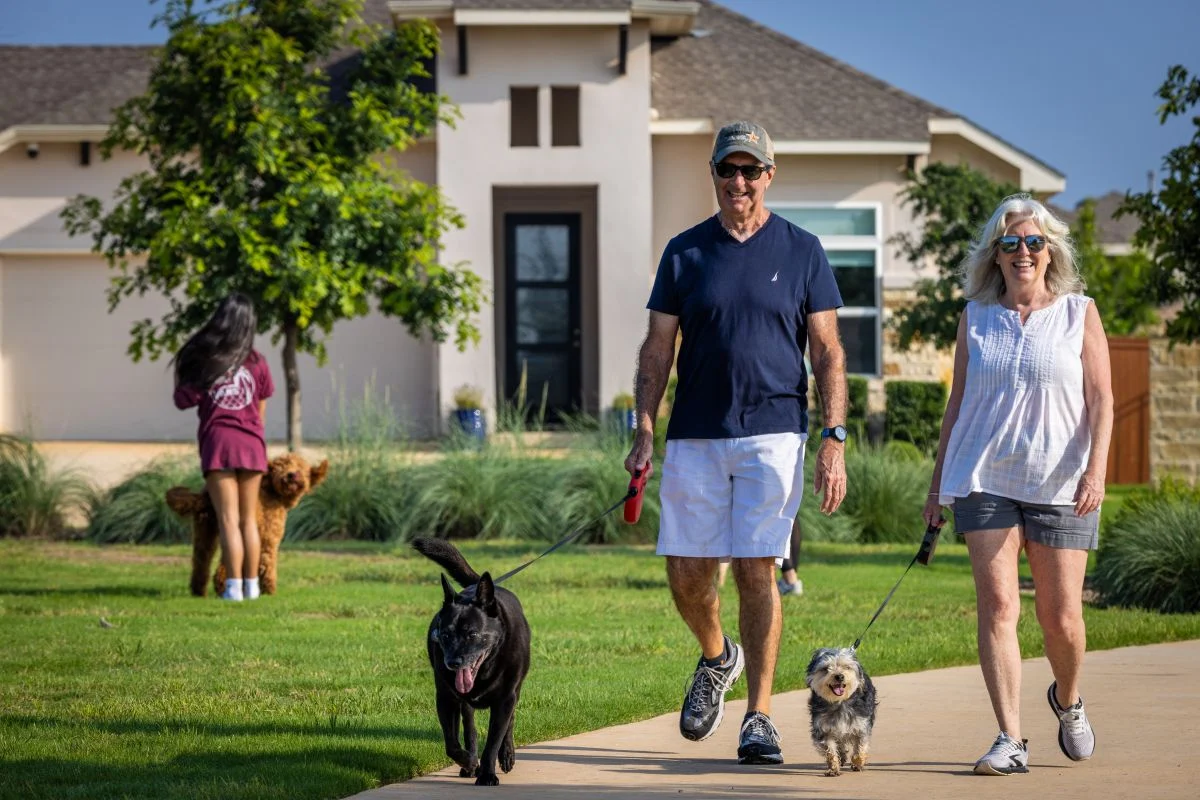 Veramendi residents walking their dogs in one of Veramendi's trails.